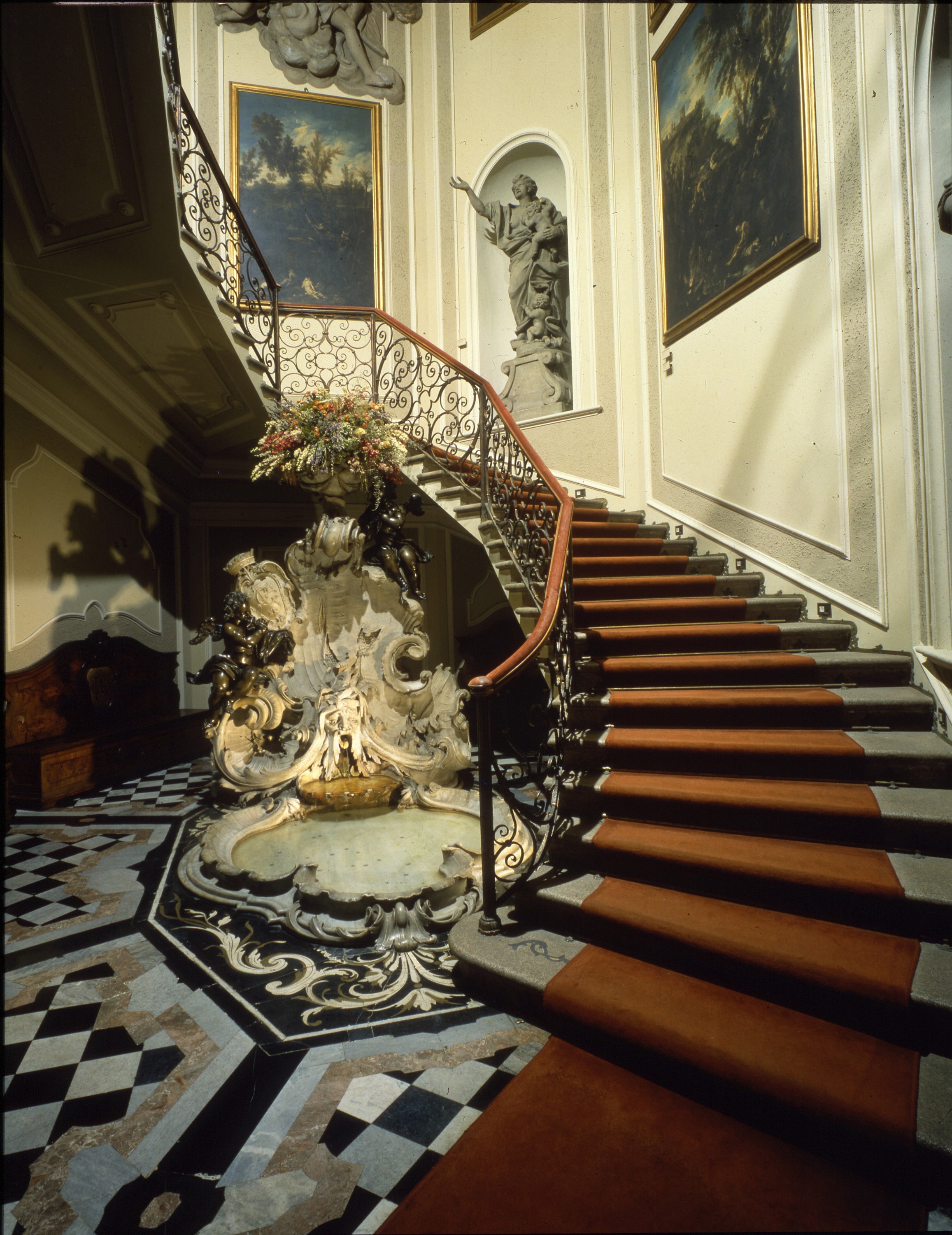 Scalone Antico. La scenografica scala barocca, impreziosita da un’elegante fontana, collega l’ingresso e gli ambienti del piano terreno alle sale del piano nobile. La scala era di accesso agli appartamenti di Pezzoli ed era stata progettata con l’antico scalone del palazzo. stucco delle pareti e il lucernario in vetro dipinto sono stati distrutti durante i bombardamenti del ’43, mentre si sono salvate cinque cassapanche in legno di noce con uno stemma dorato e la scritta “Poldi” sullo schienalea stucco delle pareti e il lucernario in vetro dipinto sono stati distrutti durante i bombardamenti del ’43, mentre si sono salvate cinque cassapanche in legno di noce con uno stemma dorato e la scritta “Poldi” sullo schienalea stucco delle pareti e il lucernario in vetro dipinto sono stati distrutti durante i bombardamenti del ’43, mentre si sono salvate cinque cassapanche in legno di noce con uno stemma dorato e la scritta “Poldi” sullo schienale.a stucco delle pareti e il lucernario in vetro dipinto sono stati distrutti durante i bombardamenti del ’43, mentre si sono salvate cinque cassapanche in legno di noce con uno stemma dorato e la scritta “Poldi” sullo schienale.e a stucco delle pareti e il lucernario in vetro dipinto sono stati distrutti durante i bombardamenti del ’43, mentre si sono salvate cinque cassapanche in legno di noce con uno stemma dorato e la scritta “Poldi” sullo schienale. (Scalone Antico © Museo Poldi Pezzoli) 