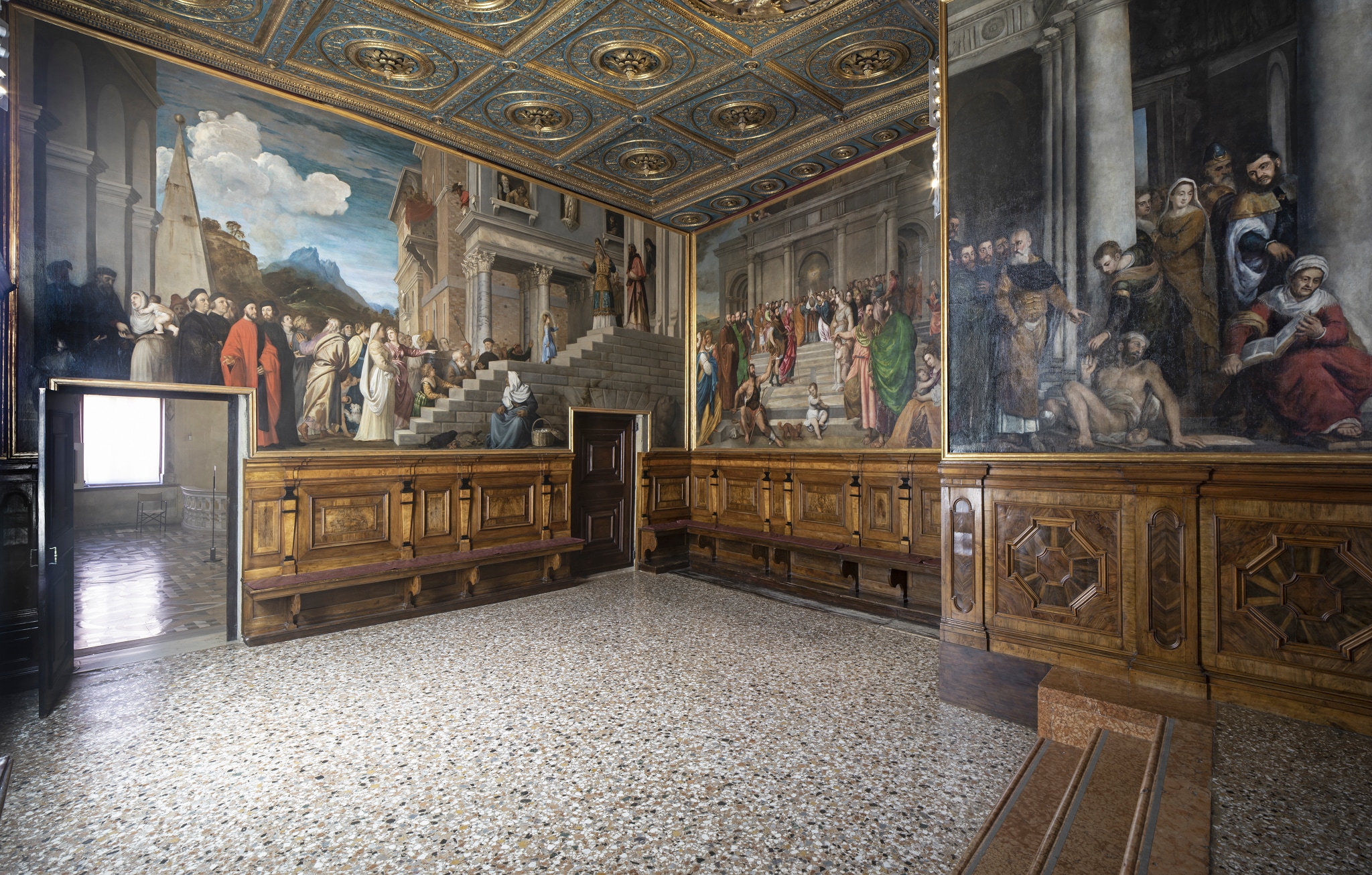 Gallerie dell’Accademia di Venezia, Primo piano, sala XXIV, sala dell’Albergo. Il soffitto dorato e policromo, di recente restauro, è tra i più importanti di Venezia in quanto è l'unico figurato del '400 sopravvissuto in laguna. Nella parete che conduce in Sala I è collocata la Presentazione di Maria al Tempio, opera di Tiziano realizzata per questo ambiente, come pure i due teleri di Giampietro Silvio e di Gerolamo Dente con fatti della vita della Vergine.