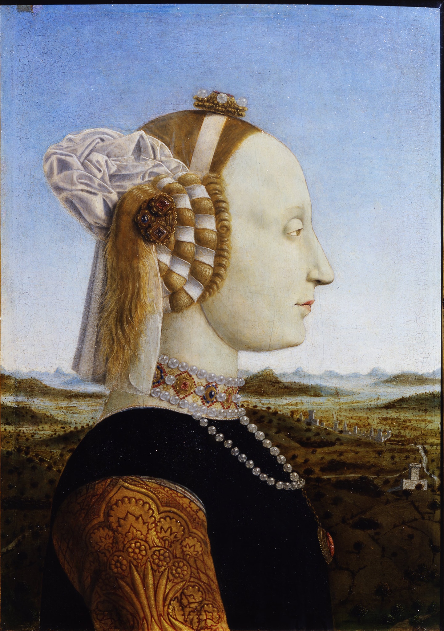 Piero della Francesca, Ritratto di Battista Sforza, 1473-1475 ca., olio su tavola 47x33cm. Opera tra le più famose dell'artista, il doppio ritratto attesta il consolidato rapporto fra il pittore e i duchi, alla cui corte, ambiente colto e raffinato, Piero soggiornò ripetutamente. La rigorosa impostazione prospettica si fonde con la lenticolare rappresentazione della natura propria della pittura fiamminga.
