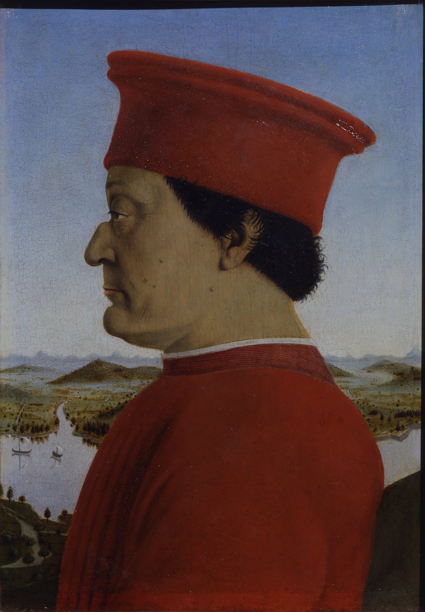 Piero della Francesca, Ritratto di Federico da Montefeltro Duca di Urbino, 1473-1475 ca., olio su tavola 47x33cm. Celebre ritratto di Federico da Montefeltro, parte del dittico con il ritratto della moglie Battista Sforza; i due signori di Urbino, in accordo con la tradizione quattrocentesca ispirata alla numismatica antica, sono rappresentati di profilo, un taglio che garantiva la verosimiglianza senza che trasparissero gli stati d’animo.