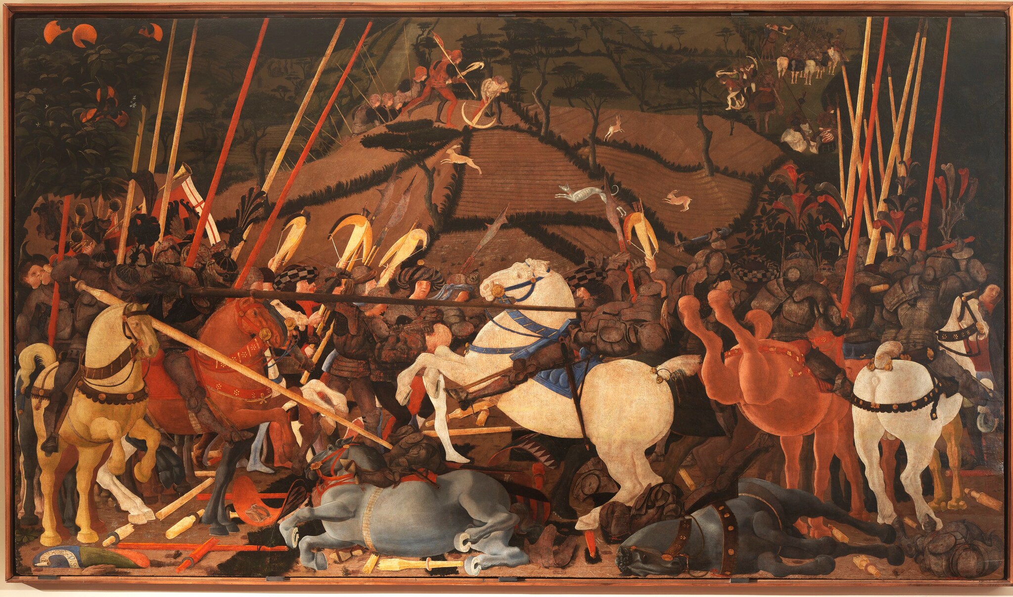 Paolo Uccello, Battaglia di San Romano, 1435-1440 ca., tempera su tavola, 182x323cm. La tavola era parte di un ciclo di tre dipinti che celebrava la vittoria dei fiorentini sulle truppe senesi e sull’alleanza guidata dal duca di Milano nella battaglia di San Romano (1432). Niccolò da Tolentino, a capo dell’esercito fiorentino, è raffigurato mentre con l’asta colpisce e disarciona Bernardino della Carda, il condottiero alla guida delle truppe avversarie.