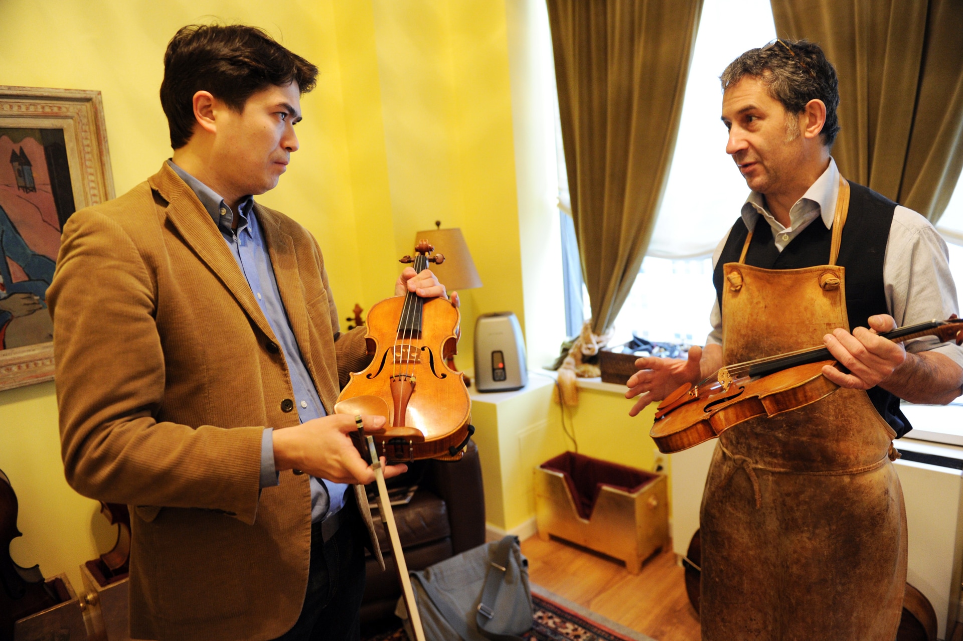2011: il violinista Omar Guey (a sinistra) parla con il liutaio Christophe Landon (New York). Guey ha in mano un violino costruito da Landon, mentre Landon ha in mano un Guarneri del 1734.