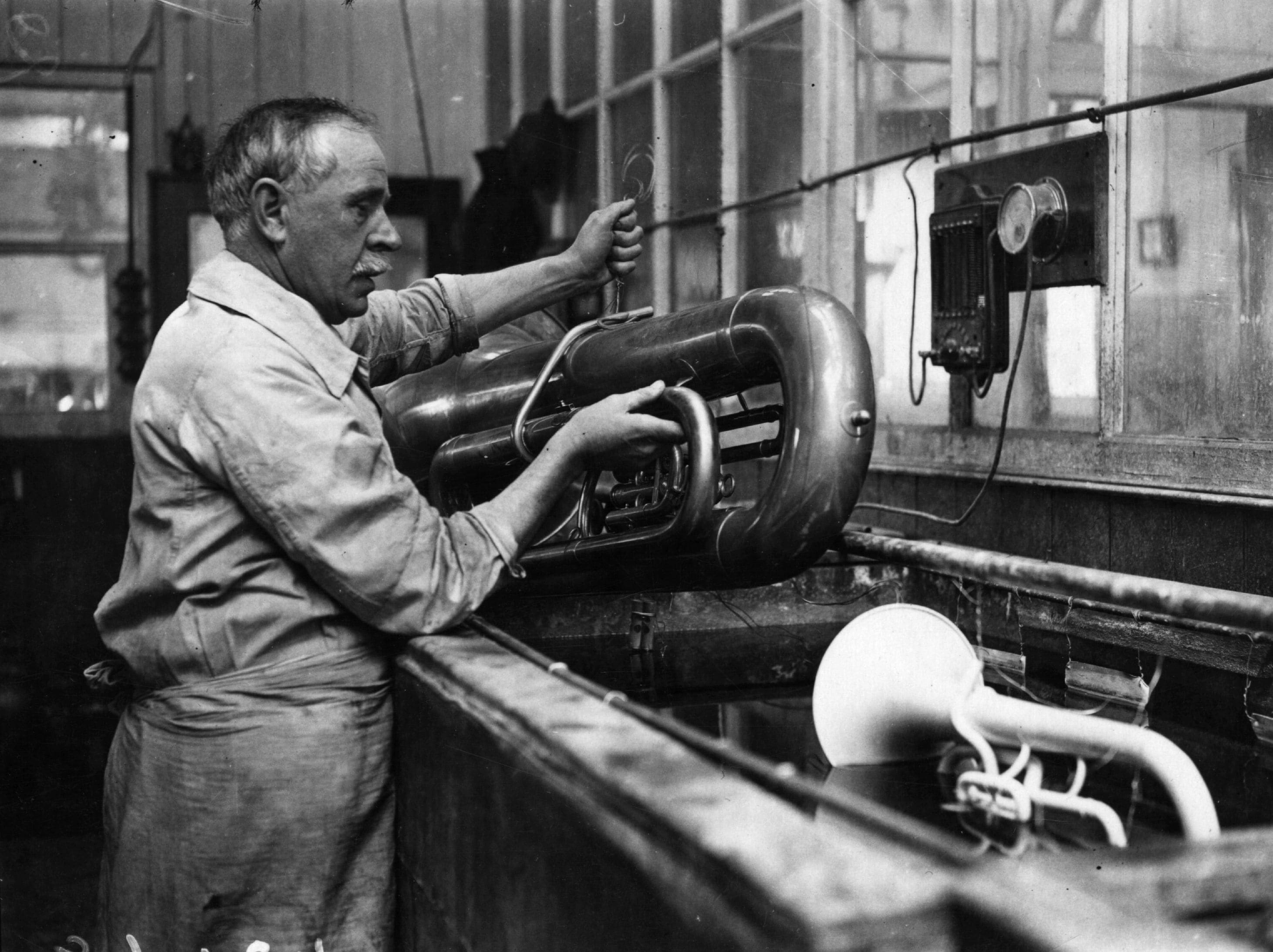 1923: un artigiano placca d'argento una tuba.