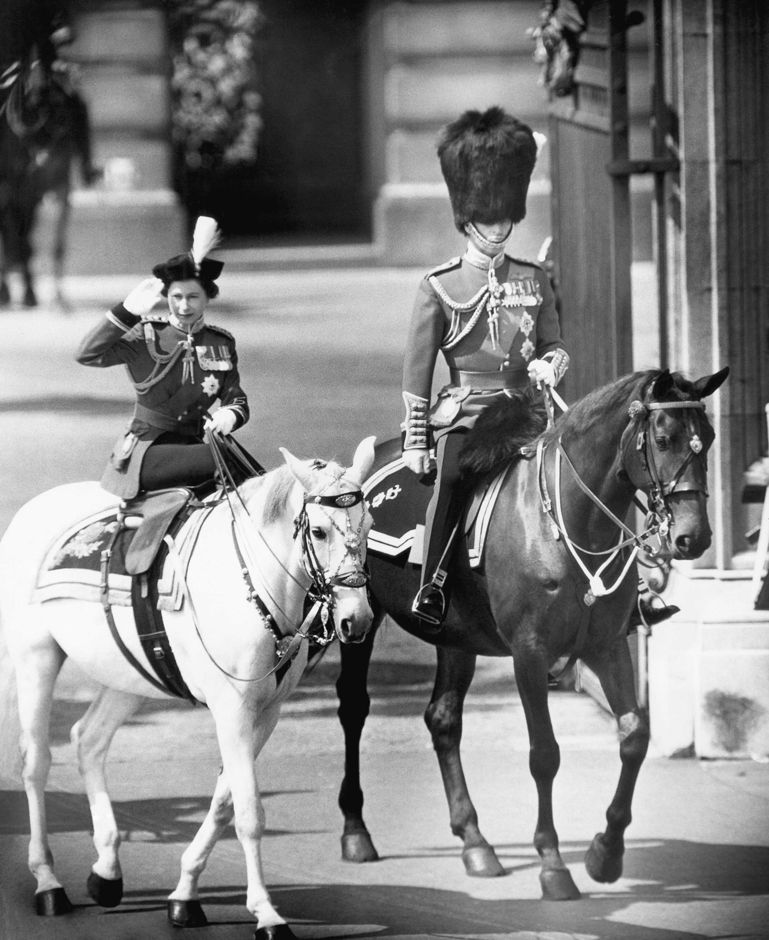 In questa foto dell'8 giugno 1963, la regina Elisabetta II fa un saluto durante la tradizionale cerimonia Trooping the Colour a Londra, mentre suo marito, il principe Filippo, cavalca al suo fianco